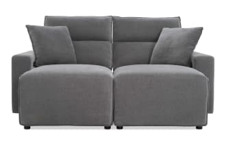 Modern gray fabric loveseat with plush cushions, wide armrests, and a minimalist design, ideal for contemporary living rooms.
