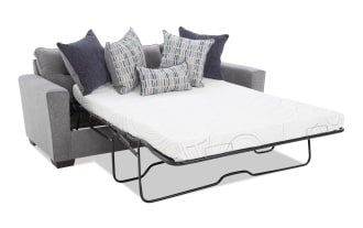 Modern gray fabric sofa with three seat cushions, wide armrests, and five decorative pillows in blue and patterned designs, ideal for living room seating.