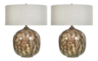 Pair of decorative table lamps with rounded, mottled brown and beige ceramic bases and large beige fabric drum shades, ideal for living room or bedroom lighting.