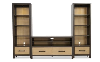 Modern entertainment center with dark brown wood frame and light wood paneling, featuring open shelves, drawers, and cable management holes.