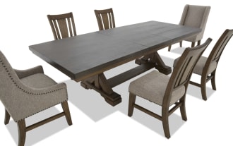 Dining table set with a dark wood rectangular table and six chairs, including two beige upholstered armchairs with nailhead trim and four matching wooden chairs with beige fabric seats.