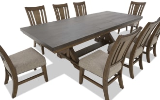 Dining set with a large rectangular dark wood table and eight wooden chairs featuring beige upholstered seats and slatted backs, suitable for family meals.