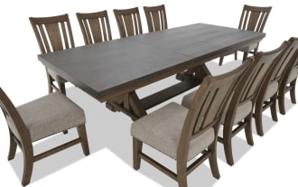 Dining set with a large rectangular dark wood table and ten matching wooden chairs featuring beige upholstered seats and nailhead trim.