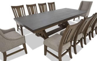Dining set with a large rectangular dark wood table and ten chairs, featuring eight wooden chairs with beige upholstered seats and two beige fabric wingback armchairs with nailhead trim.