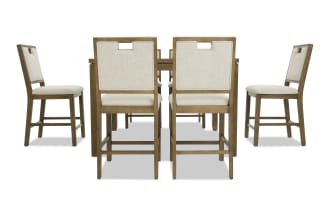Wooden dining set with six beige upholstered chairs featuring cushioned seats and backrests, sturdy frames, and a rectangular table, ideal for modern dining rooms.