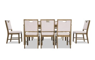 Dining set featuring a rectangular wooden table with a natural finish and six matching chairs upholstered in light beige fabric, showcasing a modern rustic style.