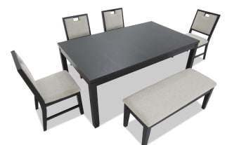 Dining set with a black wood rectangular table, four chairs with light gray cushioned seats and backs, and a matching cushioned bench.