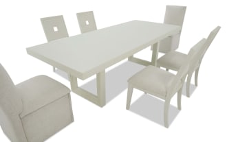 Modern beige dining set with a rectangular table and six chairs, featuring fabric upholstery and a minimalist design, ideal for contemporary dining rooms.