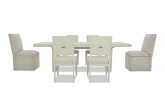 Modern beige dining set with a rectangular table and six chairs, featuring fabric upholstery and a minimalist design, ideal for contemporary dining rooms.