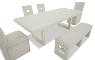 Modern white dining set featuring a rectangular table, two upholstered side chairs, two wooden back chairs, and a cushioned bench with fabric seats.