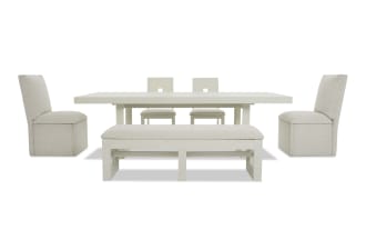 Modern white dining set featuring a rectangular table, two upholstered side chairs, two wooden back chairs, and a cushioned bench with fabric seats.