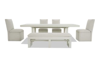 Dining set with a white rectangular extendable table, two beige upholstered side chairs, two matching chairs at the back, and a cushioned bench with white wooden legs.