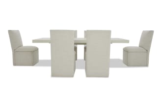 Modern dining set with six beige upholstered chairs and a rectangular light gray table, featuring a minimalist and contemporary design.