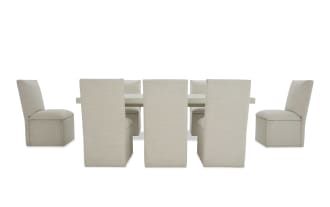 Modern dining set with a white rectangular table and eight beige upholstered fabric chairs, featuring clean lines and a minimalist design.