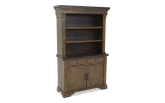 Rustic brown wooden hutch with two open shelves, two drawers, and a two-door cabinet, featuring metal handles and a plank back panel.