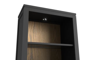 Tall black wooden cabinet with two gold handles on lower double doors and two open shelves above, featuring a dark wood back panel.