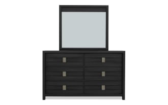 Black wooden dresser with six drawers and a rectangular mirror on top, featuring modern metal handles and a sleek, contemporary design.