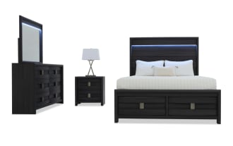 Dark wood bedroom set with a queen bed featuring a paneled headboard and footboard, matching dresser with mirror, and two-drawer nightstand with lamp.
