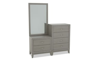 Gray wooden dresser with an attached rectangular mirror, featuring six drawers with metallic handles, modern bedroom furniture design.