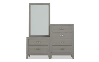 Gray wooden dresser with an attached rectangular mirror, featuring six drawers with metallic handles, modern bedroom furniture design.