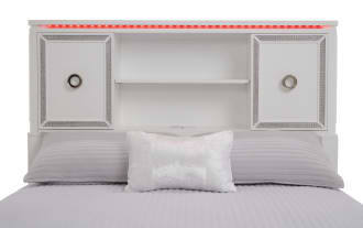 White wooden bed frame with decorative inlay, featuring a headboard with storage cabinets and open shelves, and a matching footboard.