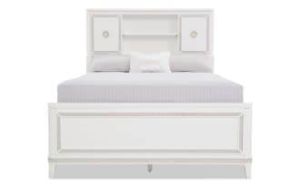 White wooden bed frame with decorative inlay, featuring a headboard with storage cabinets and open shelves, and a matching footboard.