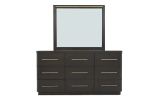 Dark wood dresser with nine drawers and brass handles, featuring a large rectangular mirror with matching brass trim, modern bedroom furniture.