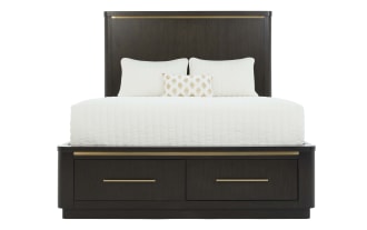 Dark wood platform bed with tall headboard and brass accents, featuring white bedding and two storage drawers at the base.