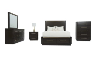 Dark wood bedroom furniture set including a bed with storage drawers, dresser with mirror, nightstand with lamp, and tall chest, featuring gold-tone handles and modern design.