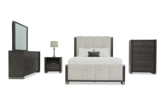 Modern bedroom set with dark wood finish, featuring a tufted upholstered bed with beige fabric, matching dresser with mirror, nightstand, and chest of drawers.