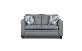 Gray fabric loveseat with modern square arms, two patterned blue and white throw pillows, and dark wooden legs, ideal for small living spaces.