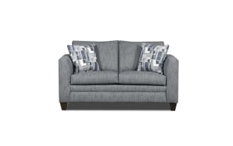 Gray fabric loveseat with modern square arms, two patterned blue and white throw pillows, and dark wooden legs, ideal for small living spaces.