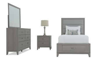 Gray wooden bedroom set with upholstered headboard, white bedding, matching dresser with mirror, and nightstand with lamp, modern style.