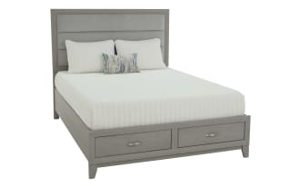 Gray wood bedroom furniture set including a bed with upholstered headboard and storage drawers, matching dresser with mirror, nightstand, and chest of drawers.