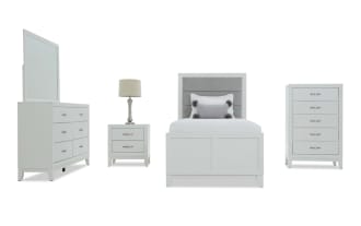 White bedroom furniture set featuring a twin bed with gray upholstered headboard, white wooden frame, matching dresser with mirror, nightstand with lamp, and tall chest of drawers.