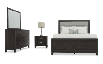 Dark wood bedroom set featuring a king-size bed with upholstered gray headboard, six-drawer dresser with mirror, and two-drawer nightstand with lamp.
