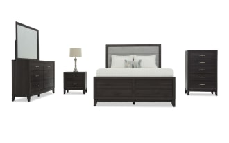 Dark wood bedroom set featuring a queen bed with upholstered headboard, six-drawer dresser with mirror, two-drawer nightstand with lamp, and five-drawer chest.
