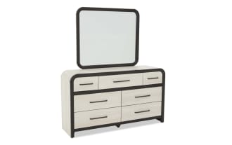 Modern dresser with six light wood-finish drawers and three smaller top drawers, featuring black rounded frame and matching square mirror.