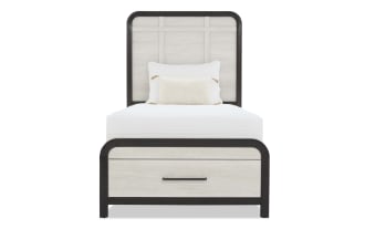 Twin bed with light wood panels and dark wood frame, featuring a tall headboard, footboard with storage drawer, and white bedding.