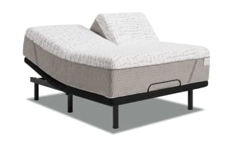 Adjustable split king bed base with dual motor incline, black metal frame, and gray fabric-covered mattress for customizable comfort and support.