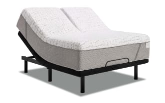 Adjustable split king bed base with white and gray quilted mattress, black metal frame, and dual motor lift for customizable comfort.
