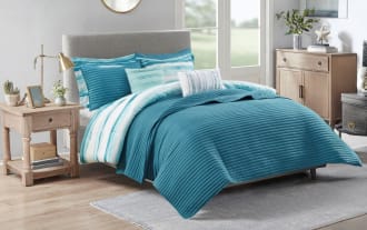 Lucas King California King Aqua 8 Piece Comforter Set in coastal style with white, aqua, and teal microfiber fabric, featuring striped and solid patterns and an extra lightweight blanket.