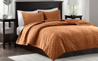 Camille King/California Orange Geometric 3 Piece Quilt Set in rich orange polyester velvet with geometric quilted design and matching shams for a glam bedroom style.