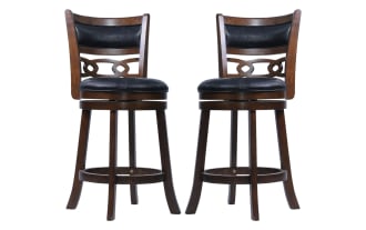 Set of two wooden bar stools with dark brown finish, black cushioned leather seats and backs, featuring decorative cutout design and footrests.