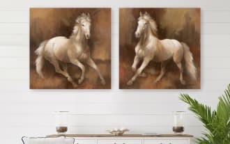 Two square canvas wall art pieces featuring realistic paintings of white horses in motion with flowing manes, set against warm brown textured backgrounds.