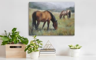 Two brown horses grazing in a misty green pasture, showcasing a serene rural landscape with soft, natural colors.
