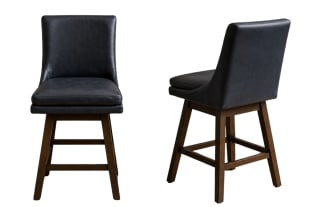 Set of two black leather swivel bar stools with cushioned seats and backs, supported by dark wooden legs and footrests, ideal for kitchen islands or home bars.