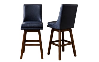 Two navy blue leather swivel bar stools with cushioned seats and backs, supported by dark brown wooden legs and footrests.