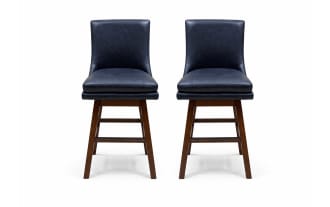 Two navy blue leather swivel bar stools with cushioned seats and backs, supported by dark brown wooden legs and footrests.