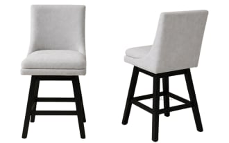 Set of two modern counter-height chairs with light gray upholstered cushioned seats and backs, featuring black wooden legs and footrests, ideal for kitchen or bar seating.